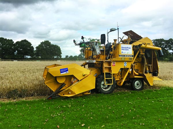 An autonomous harvester starts to cut robot-grown barley