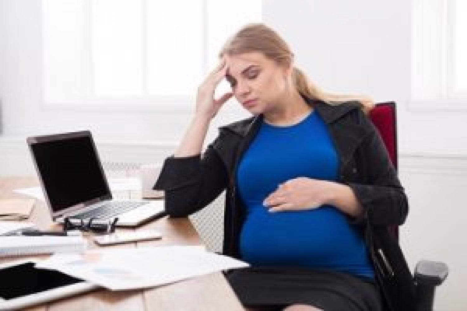 Pregnant employee at desk